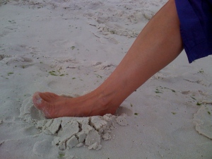 Foot rooting into the sand.